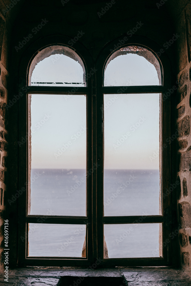 Old castle window overlooking the sea, middle ages