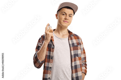 Male teenager spraying a perfume