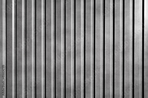 Galvanized Aluminum Fence Made Of Corrugated Silver Material. Grunge Grey Metal Plate Wall or Roof Surface. Urban Industrial City Background. 