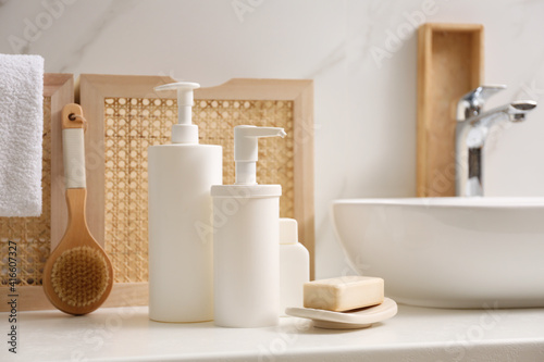 Toiletries and personal hygiene products on white countertop in bathroom