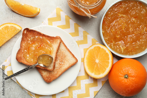Valokuva Delicious orange marmalade and toasts on light table, flat lay