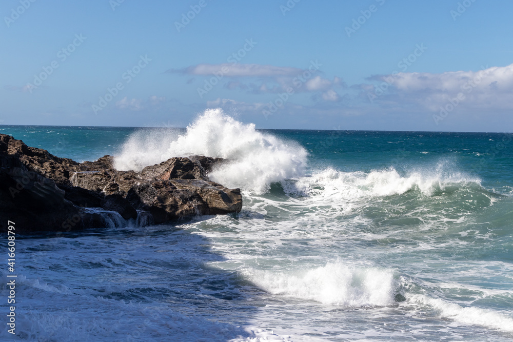 Ocean view on Ajuí beach. Beautiful view of the clear sea, waves, cliffs and beach in Playa de Ajuí - Canary Islands, Fuerteventura, Spain. Ocean view on Ajuí beach. Beautiful view of the clear sea, waves, cliffs and beach in Playa de Ajuí - Canary Islands, Fuerteventura, Spain.