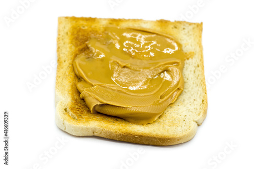 Toasted bread with peanut butter isolated on white background top view