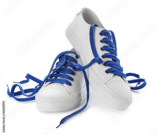 Stylish sneakers with blue shoelaces on white background