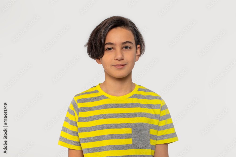 Studio shot of attractive teenager boy against grey background Studio shot of attractive teenager boy against grey background