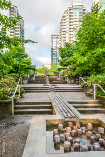Modern Apartment Buildings with flowers and water landscape in Vancouver, British Columbia, Canada. © karamysh