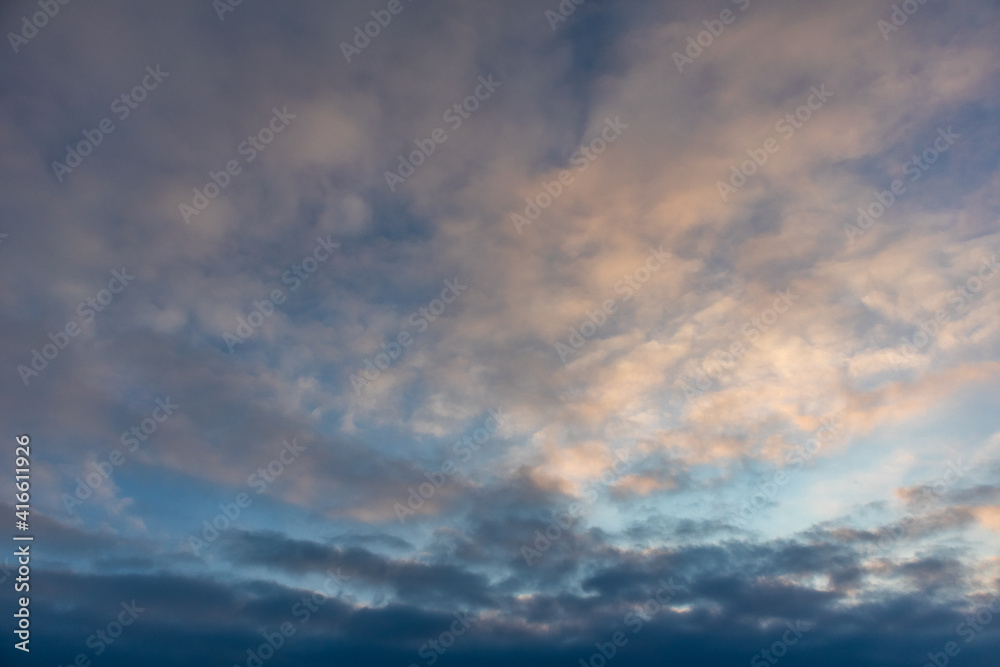 Blue and orange high layered winter sunset cold epic clouds on sky. Heaven cloudscape air view