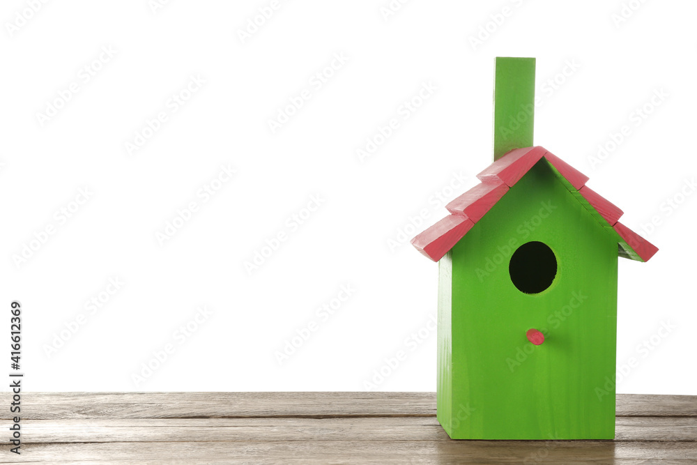 Beautiful green bird house on wooden table against white background, space for text