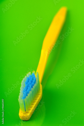 hygienic toothbrush lies on a green background.
