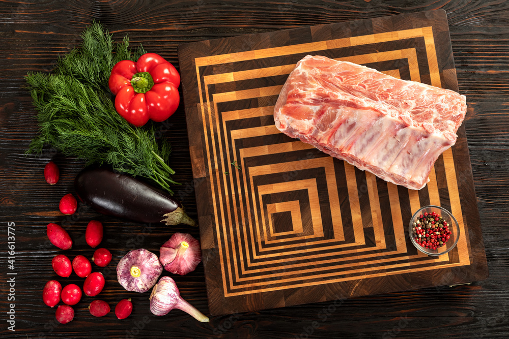 Raw pork entrecote on a board for serving.