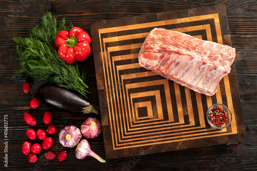 Obraz na płótnie Raw pork entrecote on a board for serving. w salonie