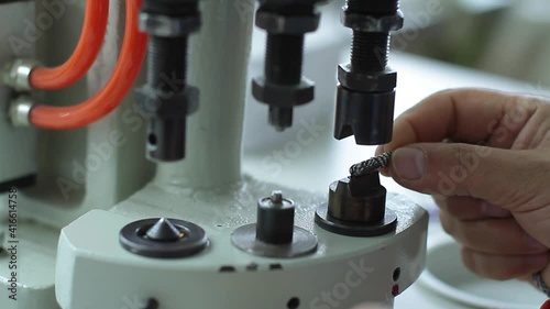 Sewing production. Machine for rivets on clothes.