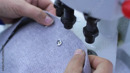 Sewing production. Machine for rivets on clothes.
