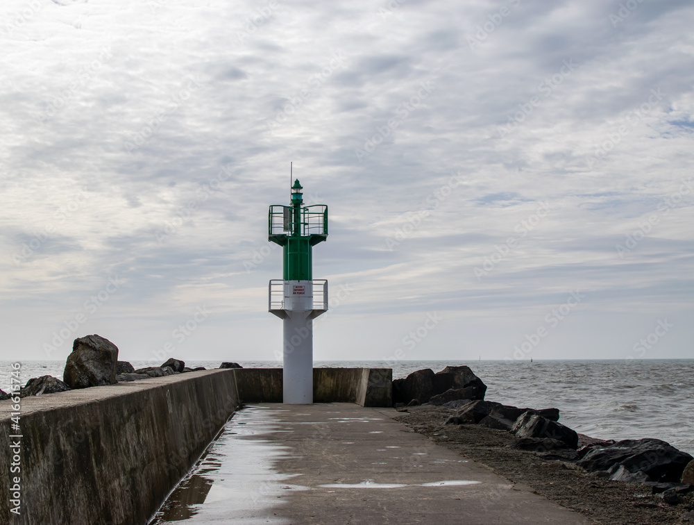 Vendée, France; February 19, 2021: Lighthouse at the entrance to the Saint Gilles Croix de Vie channel.

