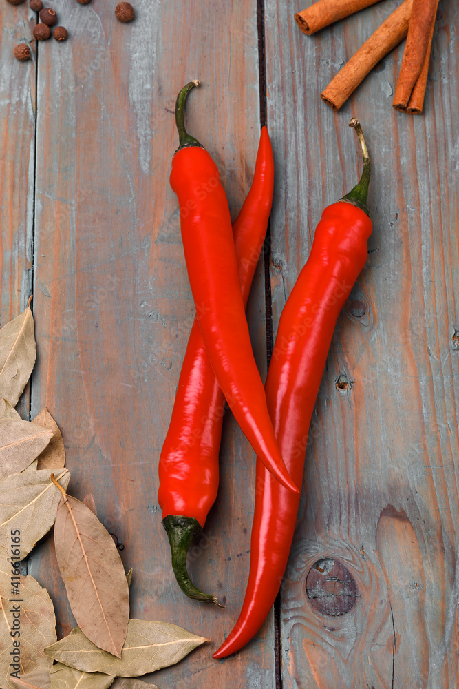 Red chili peppers and spice on a wooden surface Red chili peppers and spice on a wooden surface