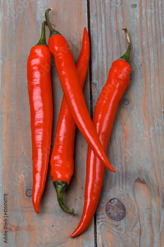 Red chili peppers on a wooden surface