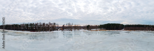 Panoramic view of a frozen lake in the spring during the thaw. Lake Titurgas in Balozi municipality