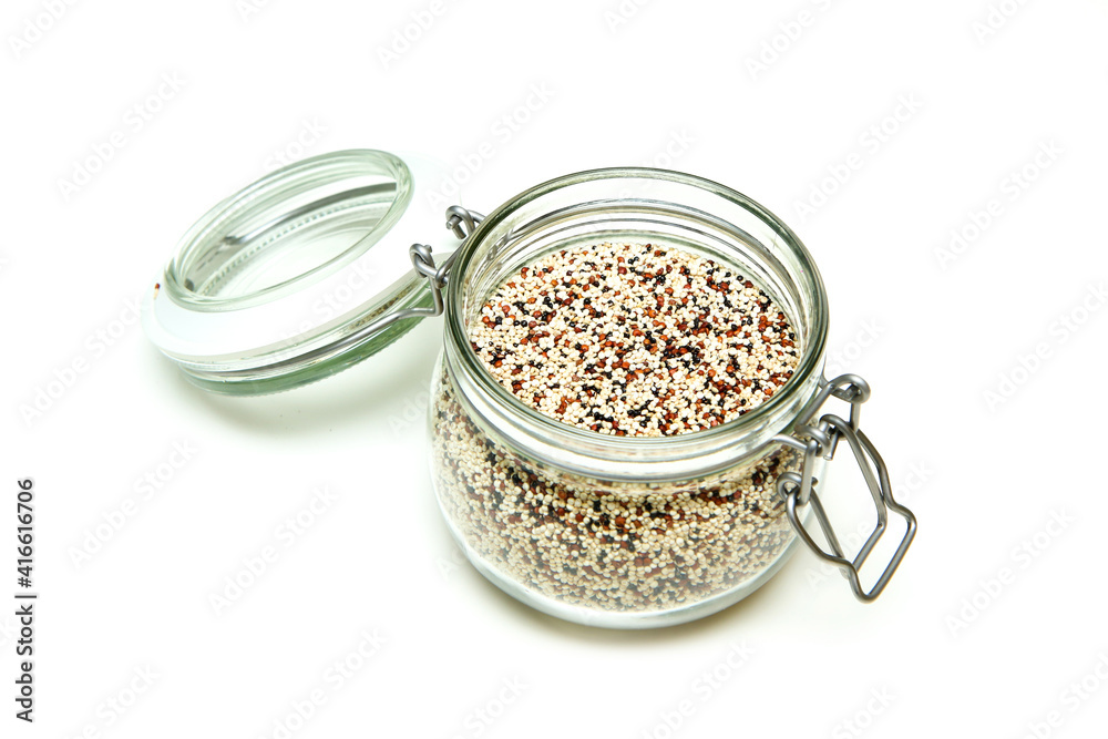 The wild quinoa stored inside the closable glass bottle isolated on a white background. The wild quinoa stored inside the closable glass bottle isolated on a white background.