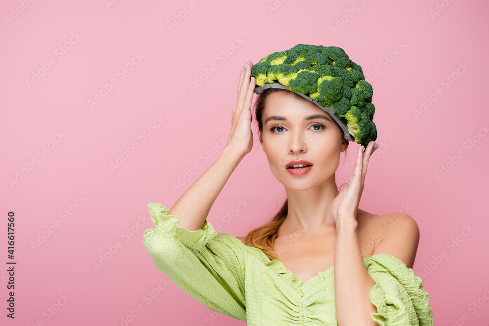 pretty woman touching hat made of fresh broccoli isolated on pink,  surrealism concept Stock Photo | Adobe Stock
