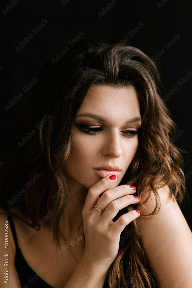 Portrait of a beautiful young sexy girl woman in a studio on a black background Portrait of a beautiful young sexy girl woman in a studio on a black background