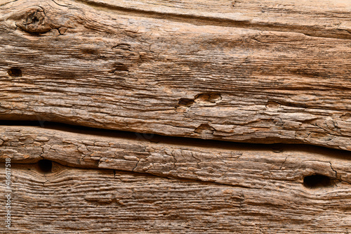 Old weathered pine wood beam from barn used as a fireplace mantel