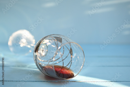 glass of red wine on blue wooden table background.