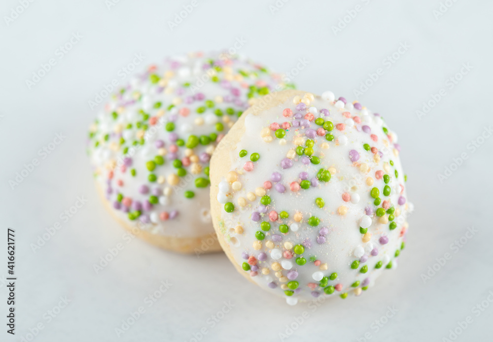 White cookies with candies on white background