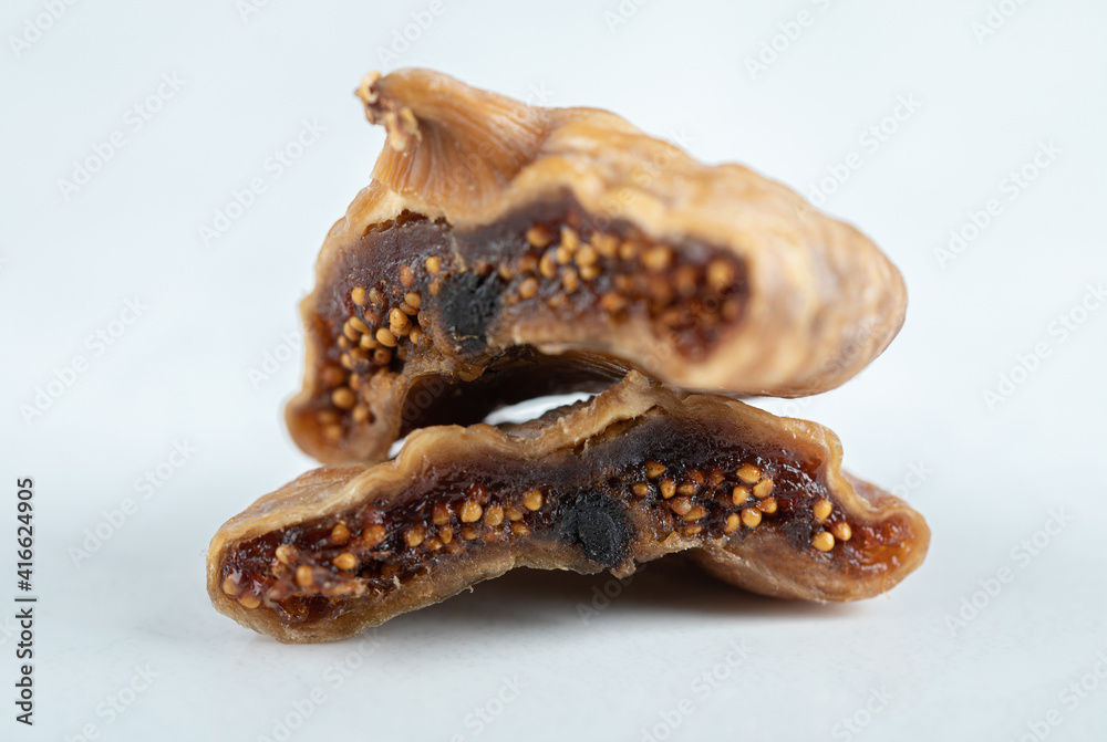 Fototapeta premium Sliced dried figs on white background