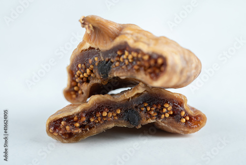 Sliced dried figs on white background