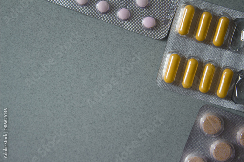 corner frameof medicines on gray background . High quality photo photo