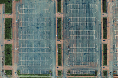 Empty car parking lots aerial top view from drone. Concrete urban background with white lines.