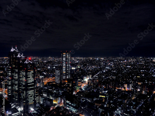 Wallpaper Mural Stunning Tokyo landscape by night under a cloudy sky, modern architecture illuminated in the dark. Torontodigital.ca