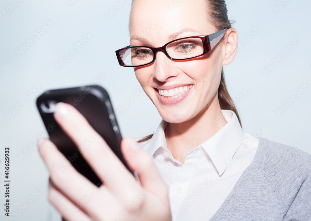 Young happy businesswoman using smartphone 