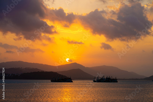 Sunset over the bay with fishing boats