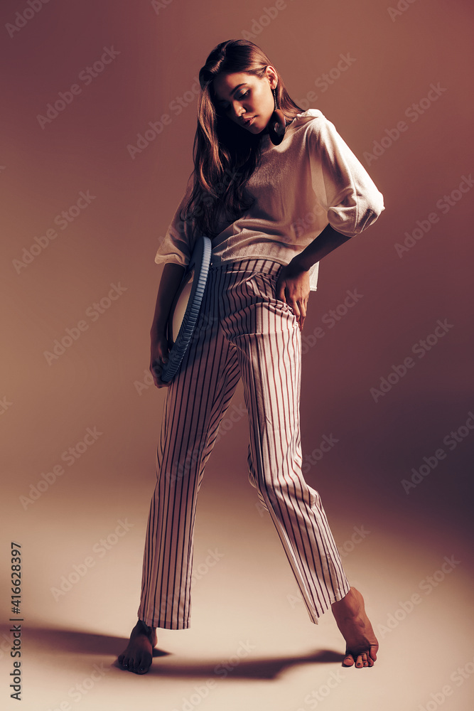 Model with mirror in hand posing in pants Model with mirror in hand posing in pants