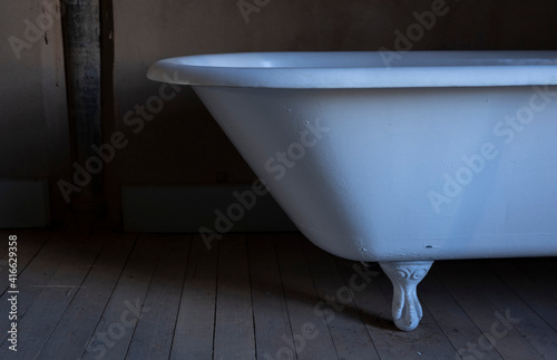 A vintage claw foot bathtub in an old building