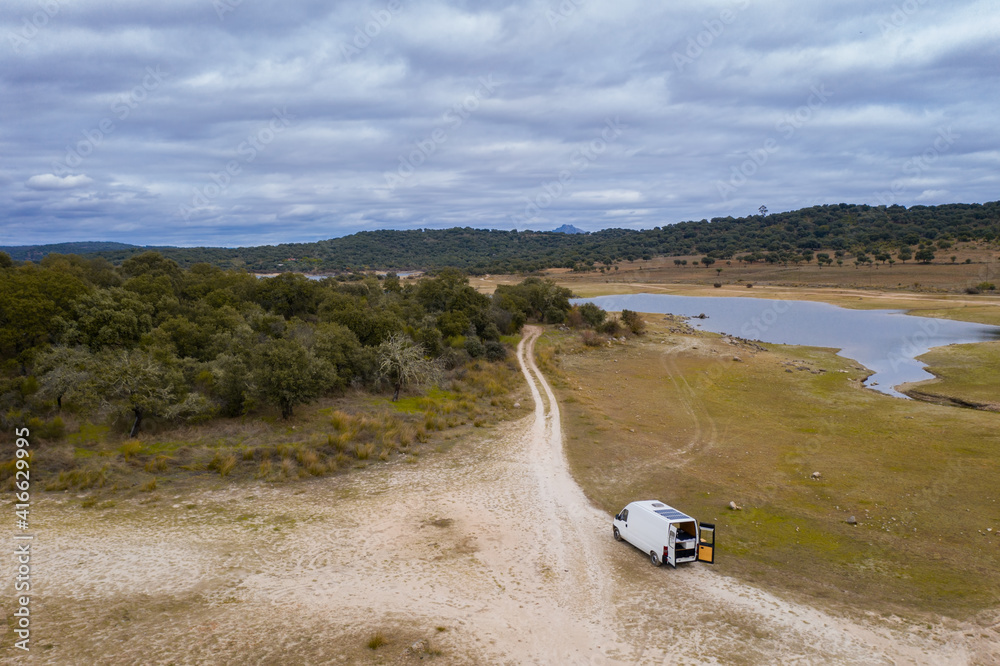 Lake drone aerial view of a camper van with solar panel living van life  mountain panorama landscape at sunset in Idanha Dam in Castelo Branco,  Portugal Stock Photo | Adobe Stock