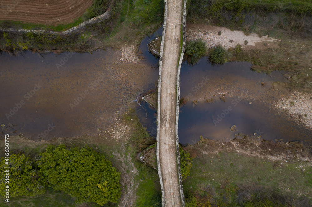 Drone aerial top above view of an ancient historic stone bridge in Idanha a velha, Portugal Drone aerial top above view of an ancient historic stone bridge in Idanha a velha, Portugal