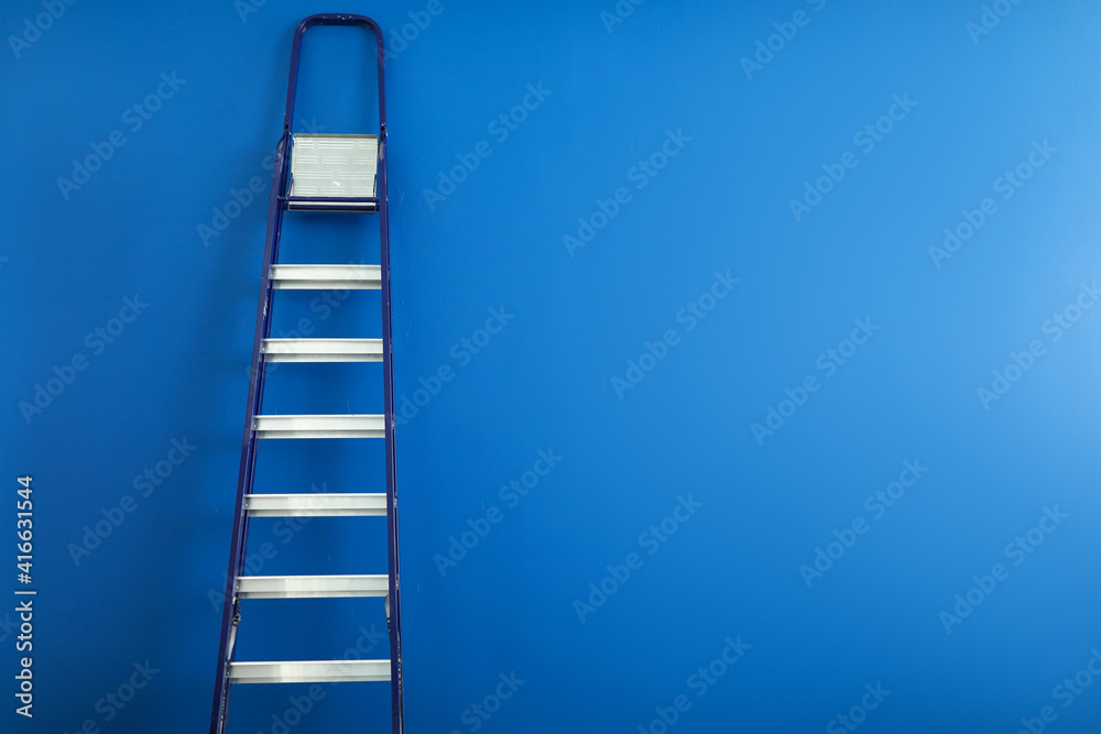 High metal ladder leaning against the wall High metal ladder leaning against the wall