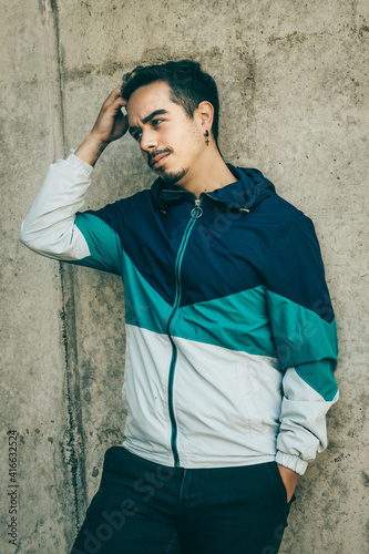 Boy with blue jacket posing