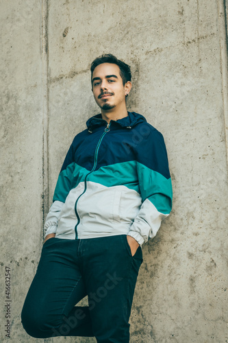 Boy with blue jacket posing