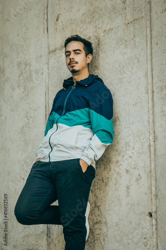 Boy with blue jacket posing