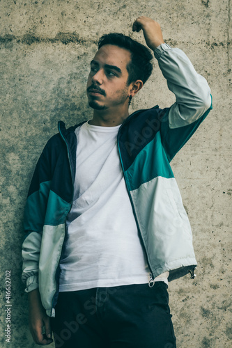 Boy with blue jacket posing
