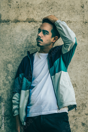 Boy with blue jacket posing