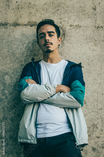 Boy with blue jacket posing