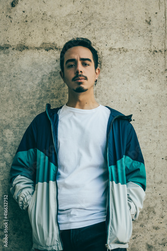 Boy with blue jacket posing