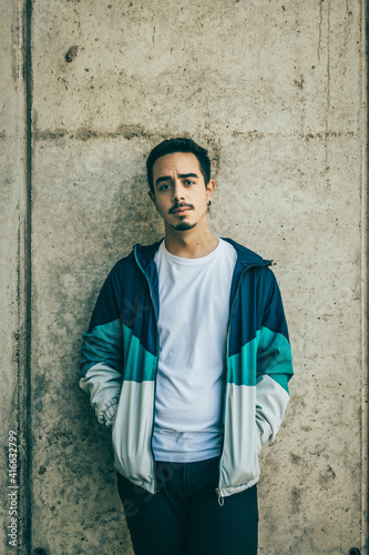 Boy with blue jacket posing
