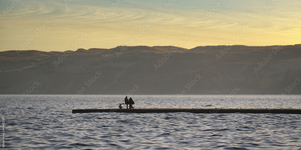 Romantic meeting at the pier at sunset. Romantic meeting at the pier at sunset.