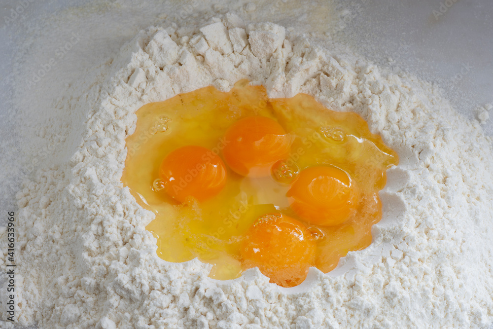 Raw chicken egg and flour on white background,homemade food, homemade pasta. Raw chicken egg and flour on white background,homemade food, homemade pasta.