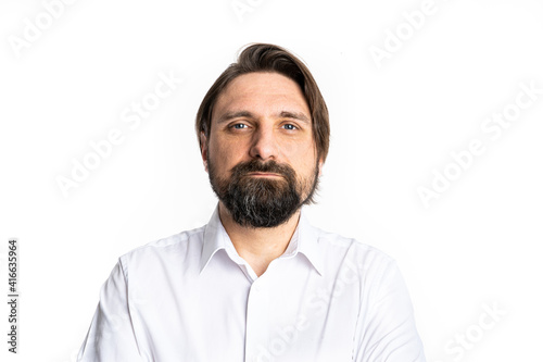 The man wearing a white shirt poses in a photo studio.